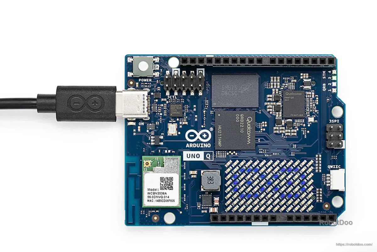 Arduino UNO Q board top view with USB-C cable connected and labeled pin headers