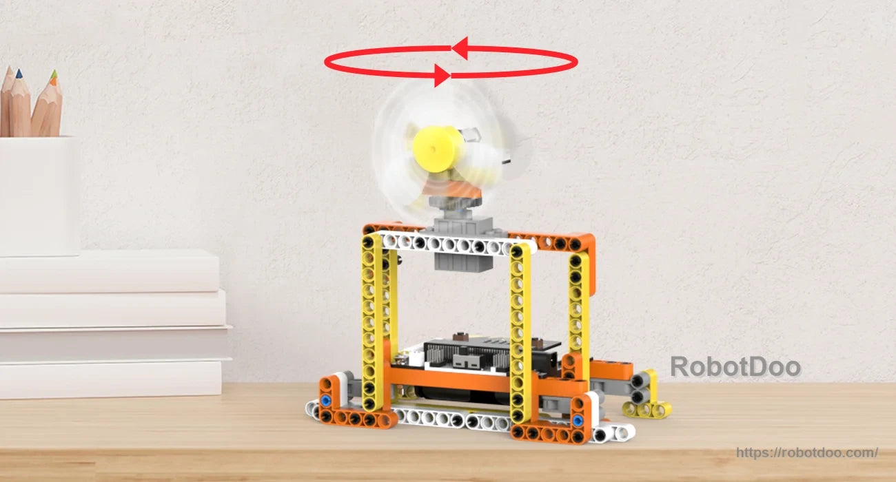 Motorized spinning fan model on a yellow and orange building-block frame