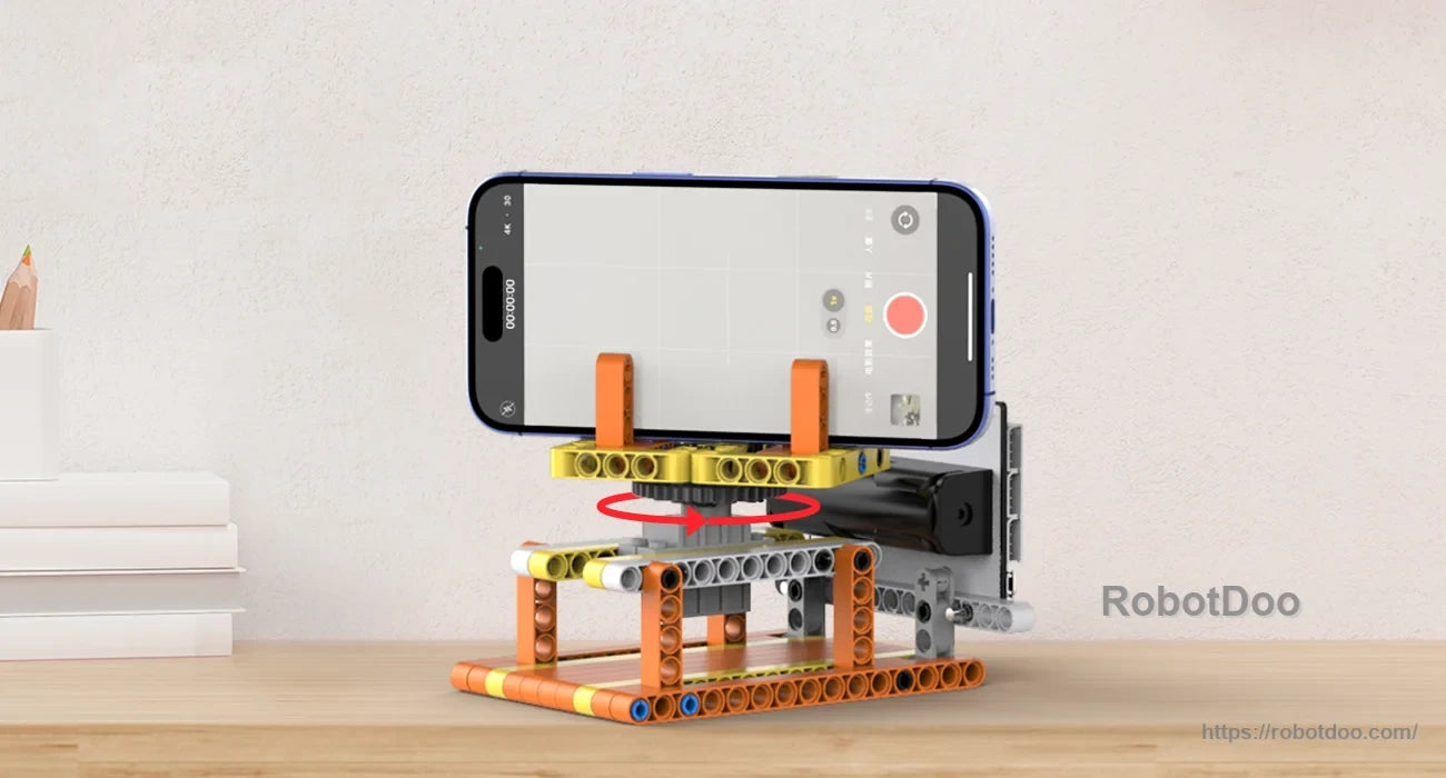 Block-built rotating phone stand with a smartphone mounted above a motorized base