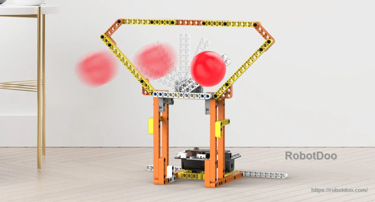 Block-built ball catcher with a wide funnel frame and red ball trajectory