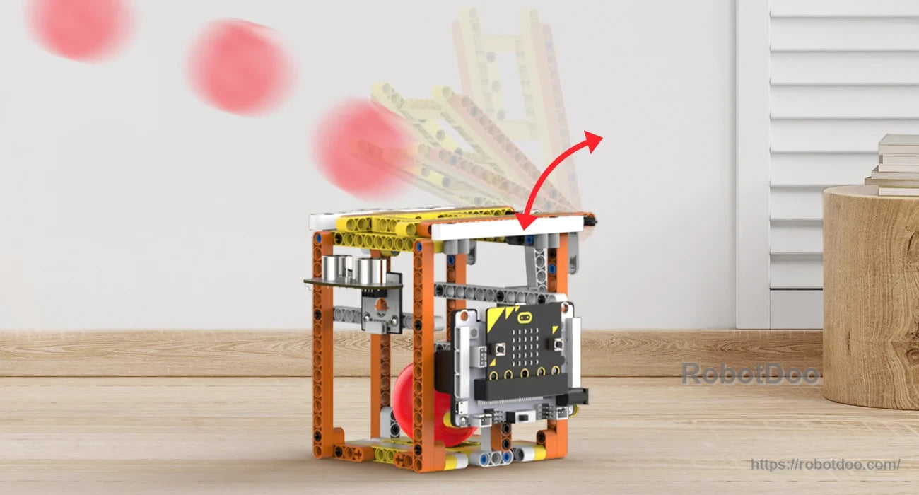 Ball-launching box model with micro:bit controller and an arcing red ball