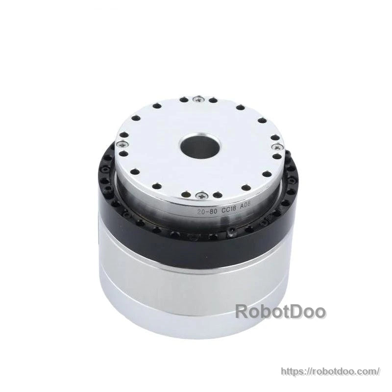 Top angled view highlighting output flange, center bore, and black ring housing between plates