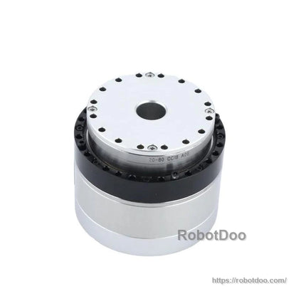 Top angled view highlighting output flange, center bore, and black ring housing between plates