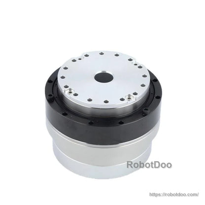 Angled top view of round motor joint module showing silver mounting plate and black ring housing