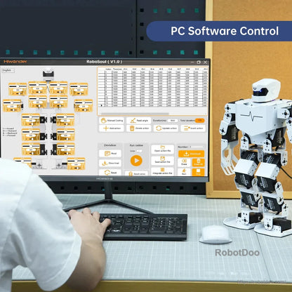 Humanoid robot beside a desktop computer running RoboSoul PC software control