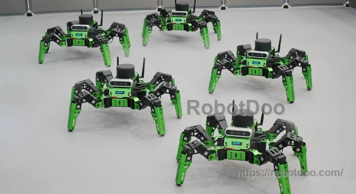Five green and black Hiwonder JetHexa ROS hexapod robots with six articulated legs on a tabletop