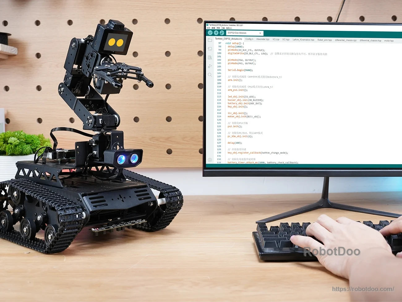 Hiwonder Tankbot ESP32-S3 tracked AI robot with robotic arm, camera module, and Arduino programming monitor