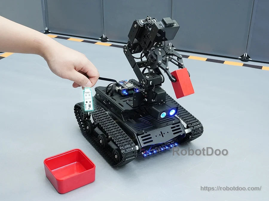 Hiwonder Tankbot ESP32-S3 tracked robot with articulated gripper arm, front LEDs, and red storage bin