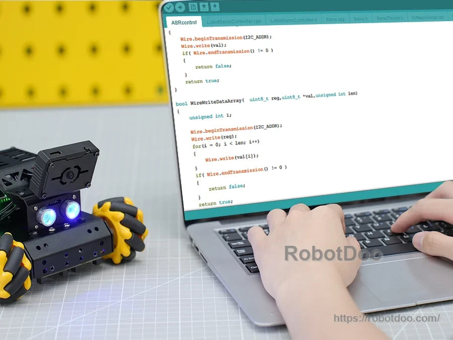 miniAuto robot beside a laptop running Arduino code for robotics programming