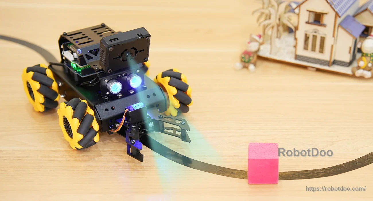 miniAuto robot with gripper following a curved line toward a pink block