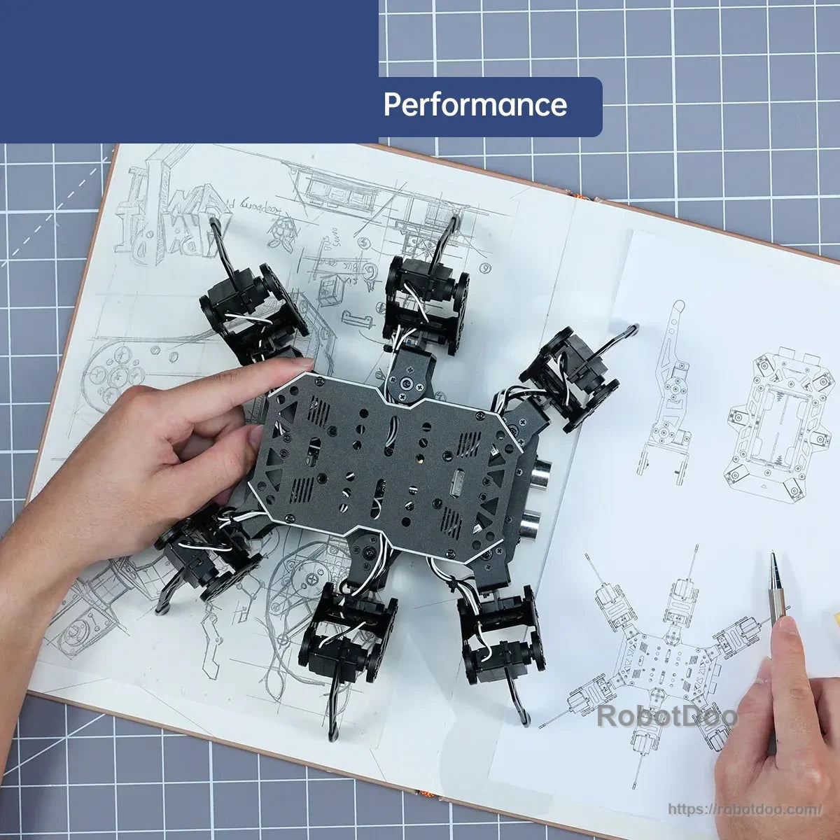 Top view of the hexapod robot being assembled over an illustrated instruction manual