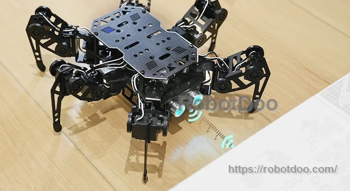 miniHexa six-legged robot detecting an obstacle on a floor with illuminated ultrasonic sensor