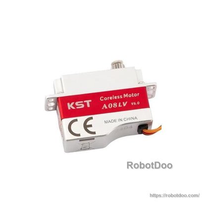 Angled underside view of KST coreless servo showing CE marking, mounting ears and cable exit