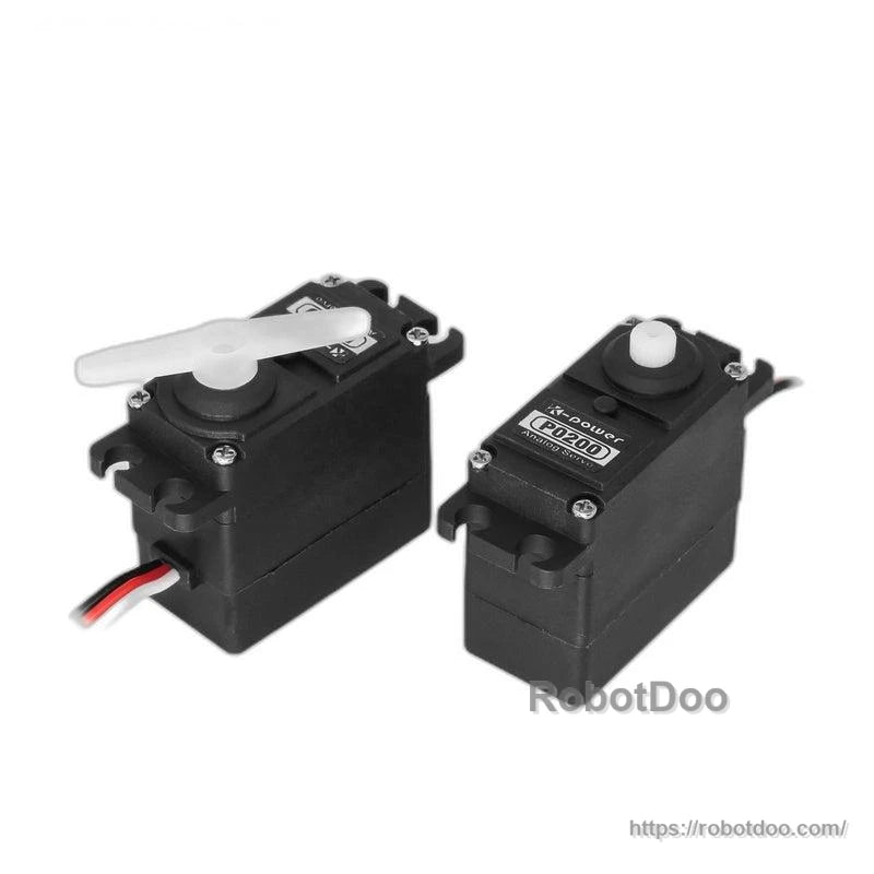 Two Kpower P0200 servos shown together, one fitted with a white servo horn on the output shaft