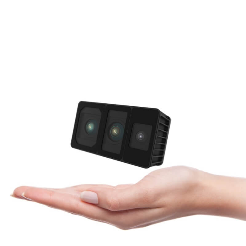 Hand holding Odin 1 spatial memory module to show compact size and three front lenses