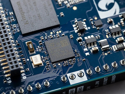 Close-up of Arduino UNO Q circuit board components, pin headers and surface-mounted processor