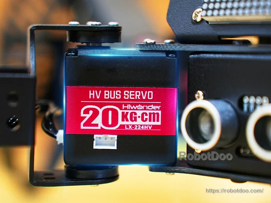 Close-up of LX-224HV 20 kg.cm high-voltage bus servo beside ultrasonic sensor