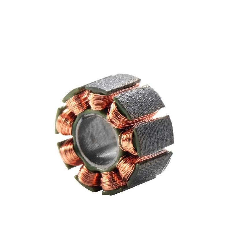 Close-up of micro motor stator showing copper coil windings and segmented core teeth